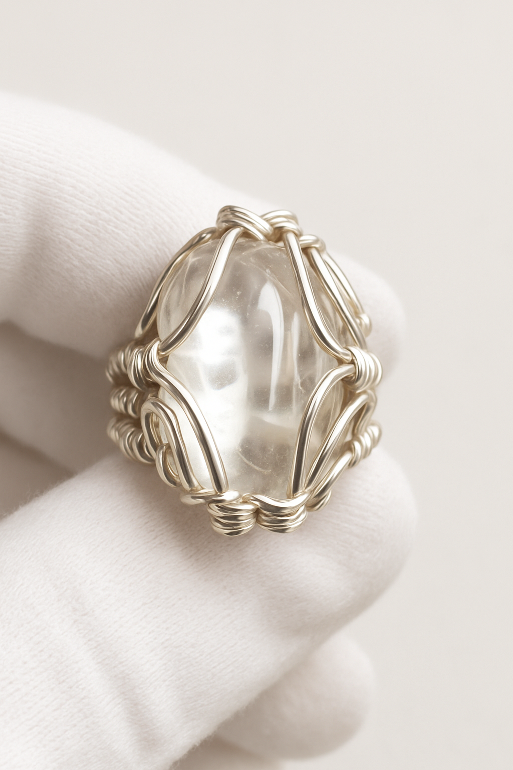 White velvet glove with exact smooth tumbled clear quartz